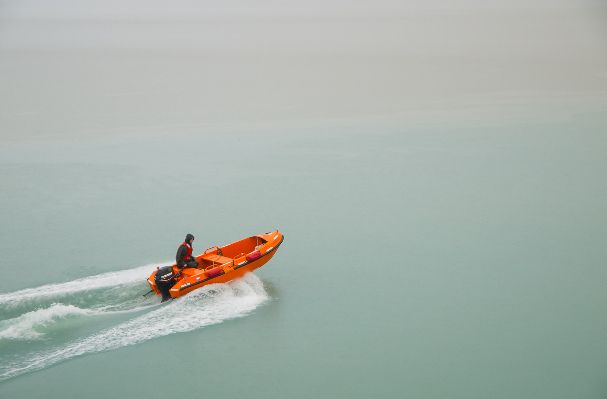 Man in orange boat, near Wrangell, Alaska